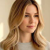 Woman with shoulder-length golden-beige waves and lighter face-framing strands, with a small label beneath identifying the shade as Beige Blonde.