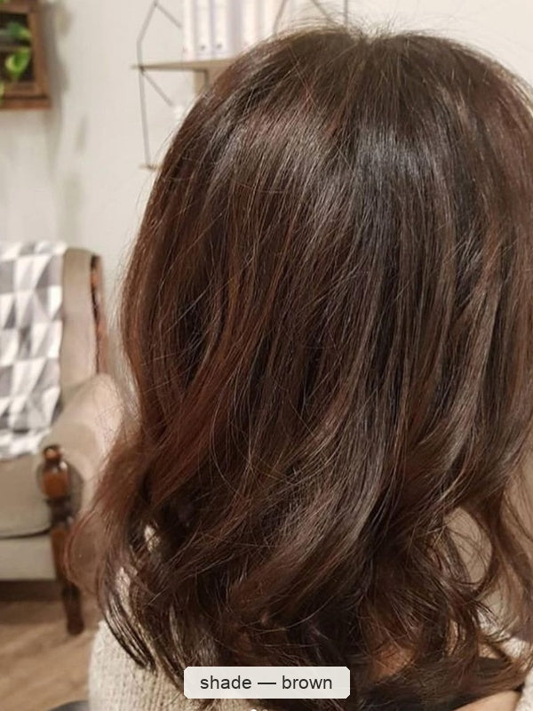 Rear view of dark brown hair falling to the shoulders in broad, loose curls, with a small label beneath identifying the shade as Brown.