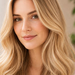 Woman modelling Radico Champagne Blonde hair colour, with a centre part, loose pale golden-blonde waves and lighter strands framing her face.