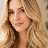 Woman modelling Radico Champagne Blonde hair colour, with a centre part, loose pale golden-blonde waves and lighter strands framing her face.