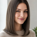 Woman with a smooth, centre-parted grey-brown bob curling inward at the shoulders, with a small label beneath identifying the shade as Dark Ash Blonde.
