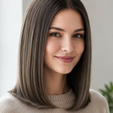 Woman with a smooth, centre-parted grey-brown bob curling inward at the shoulders, with a small label beneath identifying the shade as Dark Ash Blonde.