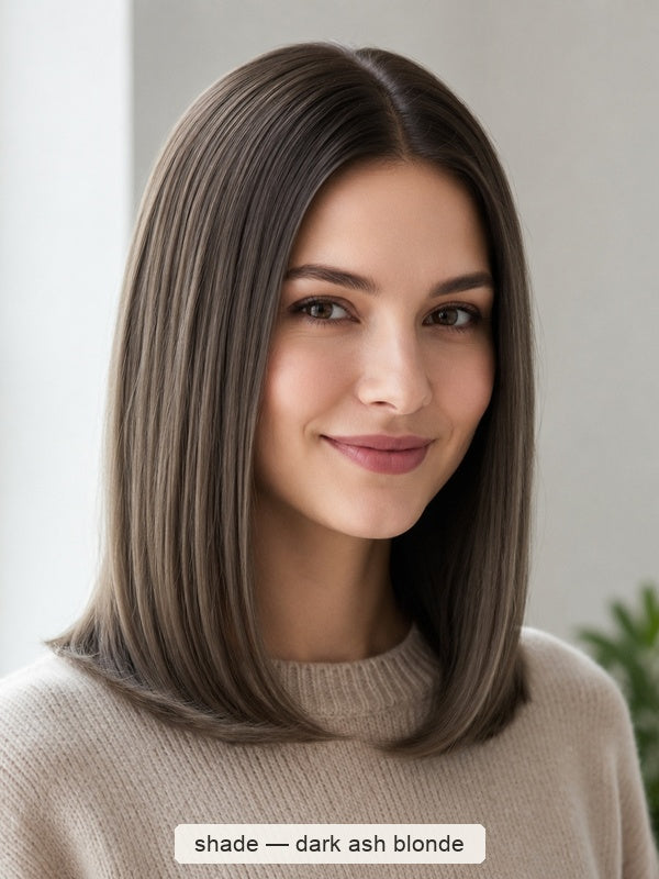 Woman with a smooth, centre-parted grey-brown bob curling inward at the shoulders, with a small label beneath identifying the shade as Dark Ash Blonde.