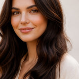 Woman modelling Radico Dark Brown hair colour, with a centre part and long, glossy dark brown waves falling over her shoulders.