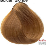 Rounded teardrop-shaped tuft of smooth, warm golden-brown hair beneath the shade name Golden Blonde, with the Radico Colour Me Organic logo at the lower right.