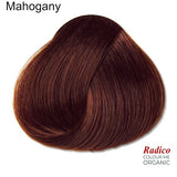 Rounded teardrop-shaped tuft of smooth, deep wine-brown hair beneath the shade name Mahogany, with the Radico Colour Me Organic logo at the lower right.