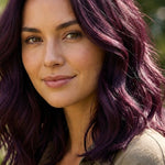 Woman modelling Radico Violet hair colour outdoors, with shoulder-length plum-purple waves and brighter violet strands catching the light.
