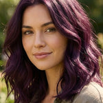 Woman outdoors with shoulder-length plum-purple waves and brighter violet highlights, with a small label beneath identifying the shade as Violet.