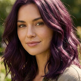 Woman outdoors with shoulder-length plum-purple waves and brighter violet highlights, with a small label beneath identifying the shade as Violet.