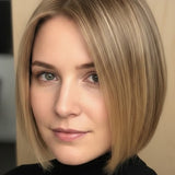 Woman with a smooth, side-parted golden-beige bob ending at her chin, with a small label beneath identifying the shade as Wheat Blonde.