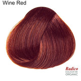 Rounded teardrop-shaped tuft of smooth, deep red hair with copper-red highlights beneath the shade name Wine Red, with the Radico Colour Me Organic logo at the lower right.