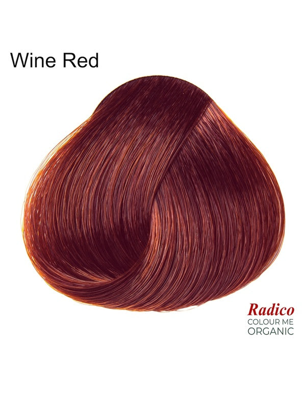 Rounded teardrop-shaped tuft of smooth, deep red hair with copper-red highlights beneath the shade name Wine Red, with the Radico Colour Me Organic logo at the lower right.