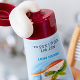 Red Seal Baking Soda Hydroxyapatite Toothpaste being squeezed beside a toothbrush