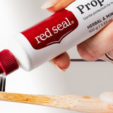 Red Seal Propolis Toothpaste being applied to a toothbrush