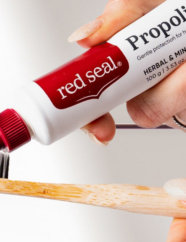 Red Seal Propolis Toothpaste being applied to a toothbrush