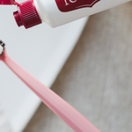 Red Seal Strong Mint Toothpaste being applied to a toothbrush