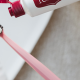 Red Seal Strong Mint Toothpaste being applied to a toothbrush