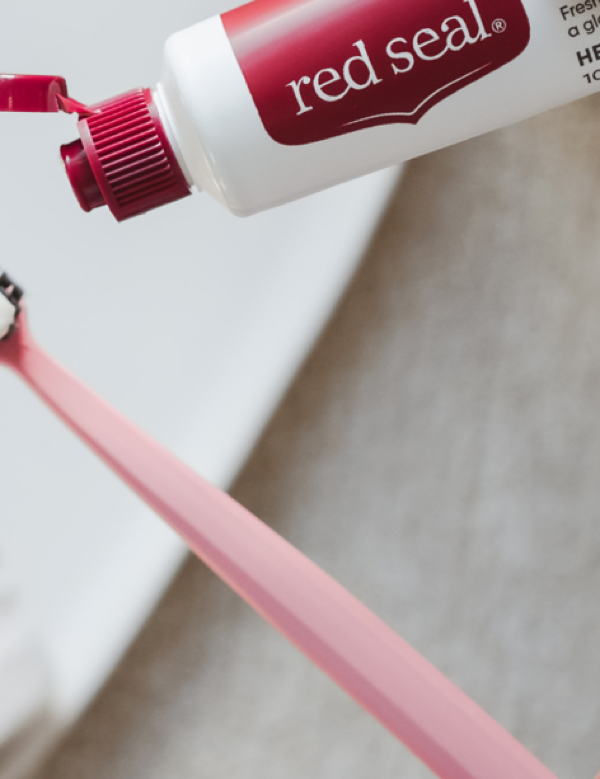 Red Seal Strong Mint Toothpaste being applied to a toothbrush
