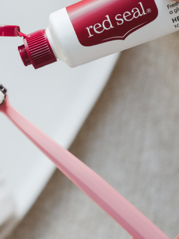 Red Seal Strong Mint Toothpaste being applied to a toothbrush