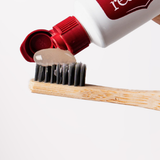 Red Seal Whitening Toothpaste being applied to a toothbrush