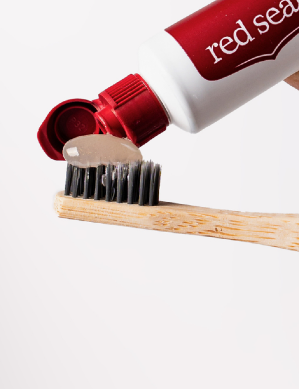 Red Seal Whitening Toothpaste being applied to a toothbrush