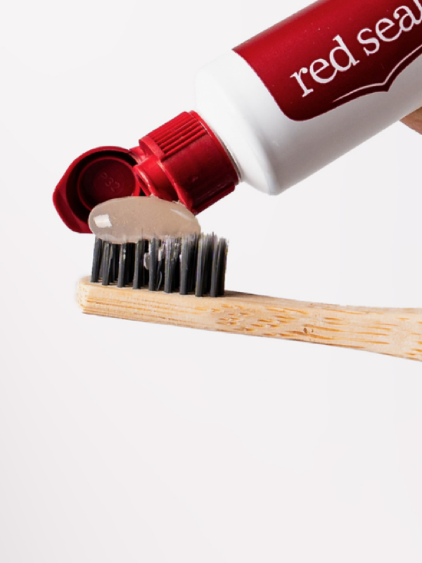 Red Seal Whitening Toothpaste being applied to a toothbrush