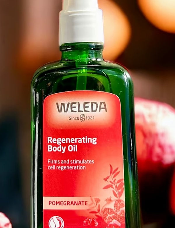 Weleda Regenerating Body Oil Pomegranate styled with pomegranates