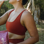 Woman drinking Ritua Creatine Monohydrate after exercise