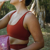 Woman drinking Ritua Creatine Monohydrate after exercise