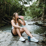 Woman drinking Berry Hydrate outdoors – Ritua Hydrate lifestyle