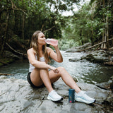 Woman drinking Berry Hydrate outdoors – Ritua Hydrate lifestyle