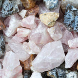Assorted rose quartz and mineral crystals used as a visual for Acure Resurfacing Overnight Glycolic Treatment.