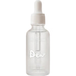Frosted cylindrical Salt + Glow Dew serum bottle with a white dropper cap and the word Dew printed in large white script across the front.