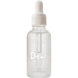 Frosted cylindrical Salt + Glow Dew serum bottle with a white dropper cap and the word Dew printed in large white script across the front.