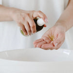 Salt + Glow Eden Cleansing Oil dispensed into the hands