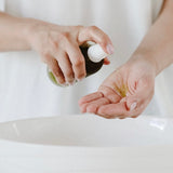 Salt + Glow Eden Cleansing Oil dispensed into the hands