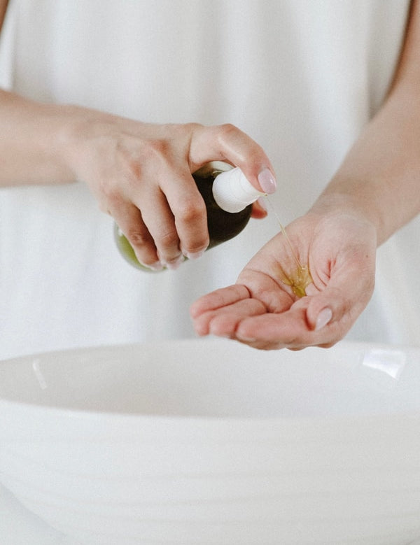Salt + Glow Eden Cleansing Oil dispensed into the hands