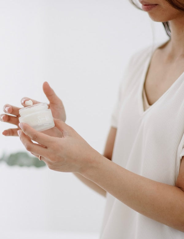Woman holding Salt + Glow Skin Soufflé moisturiser