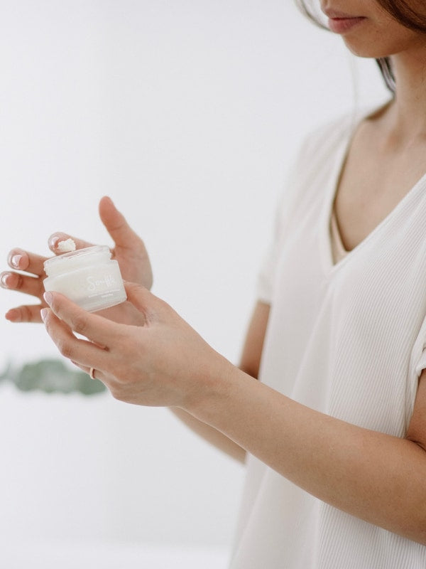 Woman holding Salt + Glow Skin Soufflé moisturiser