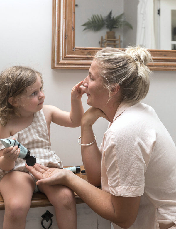 Woman and child enjoying a skincare moment with Sanctum Hydrating Gel Mask at home.