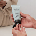 Sanctum Moisture Concentrate tube held in hands during a skincare routine.