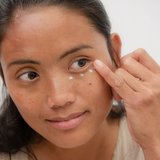 Woman applying Sanctum Firming Eye Balm