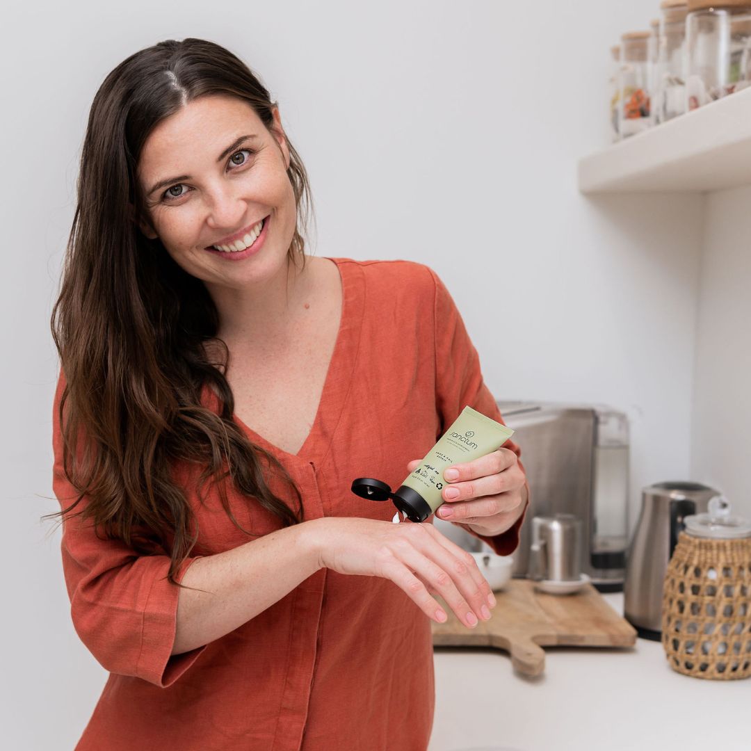 Woman applying Sanctum Hand and Nail Repair
