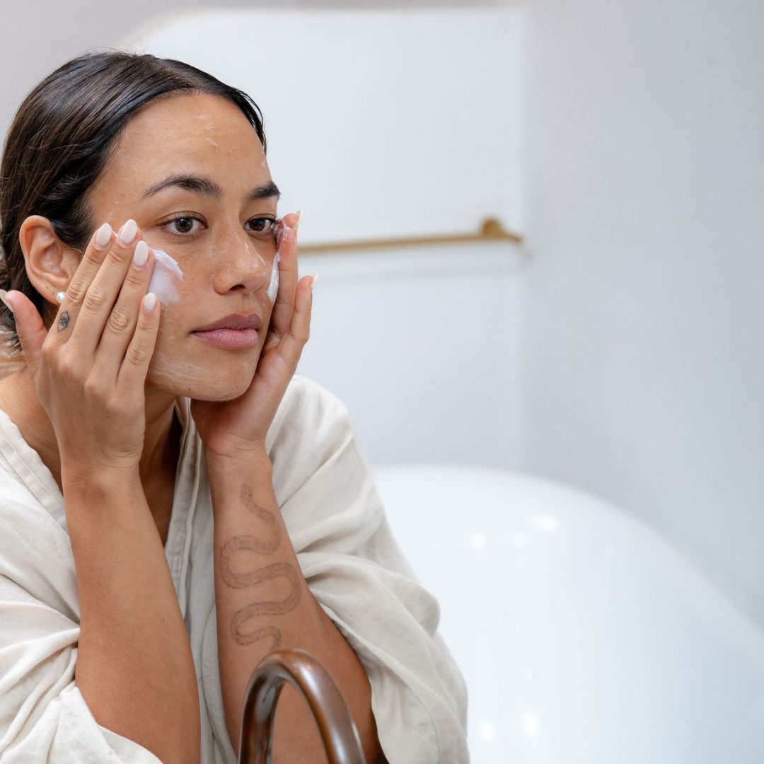 Woman applying Sanctum HY C Intensive Repair Cream