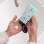 Sanctum Soothing Cream Cleanser dispensed into a hand