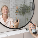 Woman misting her face with Sanctum Tone and Refresh Mist