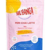 Pink resealable She BANG! Peri Chai Latte pouch with a bright yellow patch at the upper left, a curved blue panel along the bottom, scattered white dots and bold red lettering.