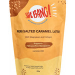 Golden-yellow resealable She BANG! Peri Salted Caramel Latte pouch with curved brown and pale gold patches, scattered dots and a bold red She BANG! logo near the top.