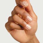 Close-up of a hand showing clear glossy nails prepared with Sienna Byron Bay Base Coat.