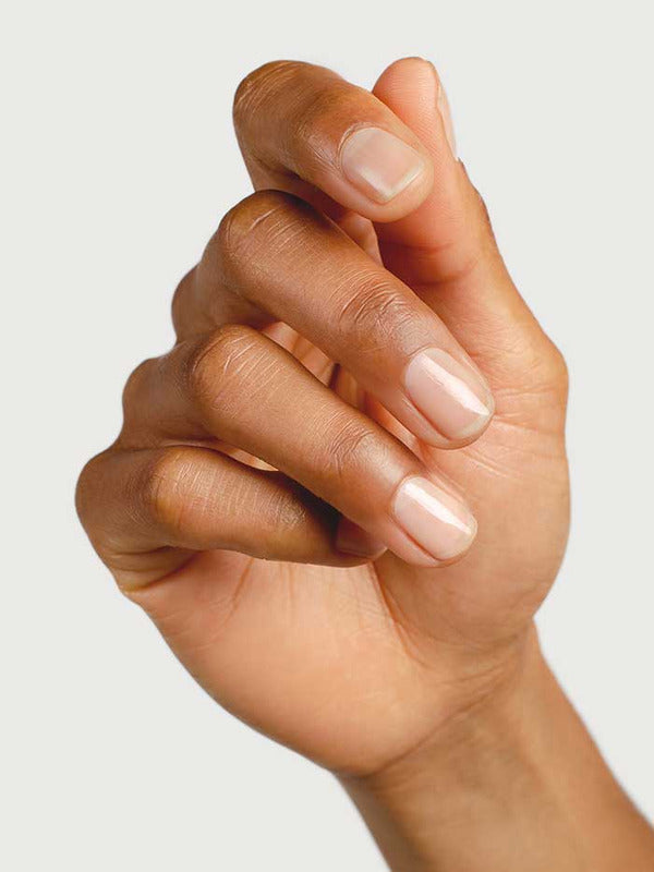 Close-up of a hand showing clear glossy nails prepared with Sienna Byron Bay Base Coat.